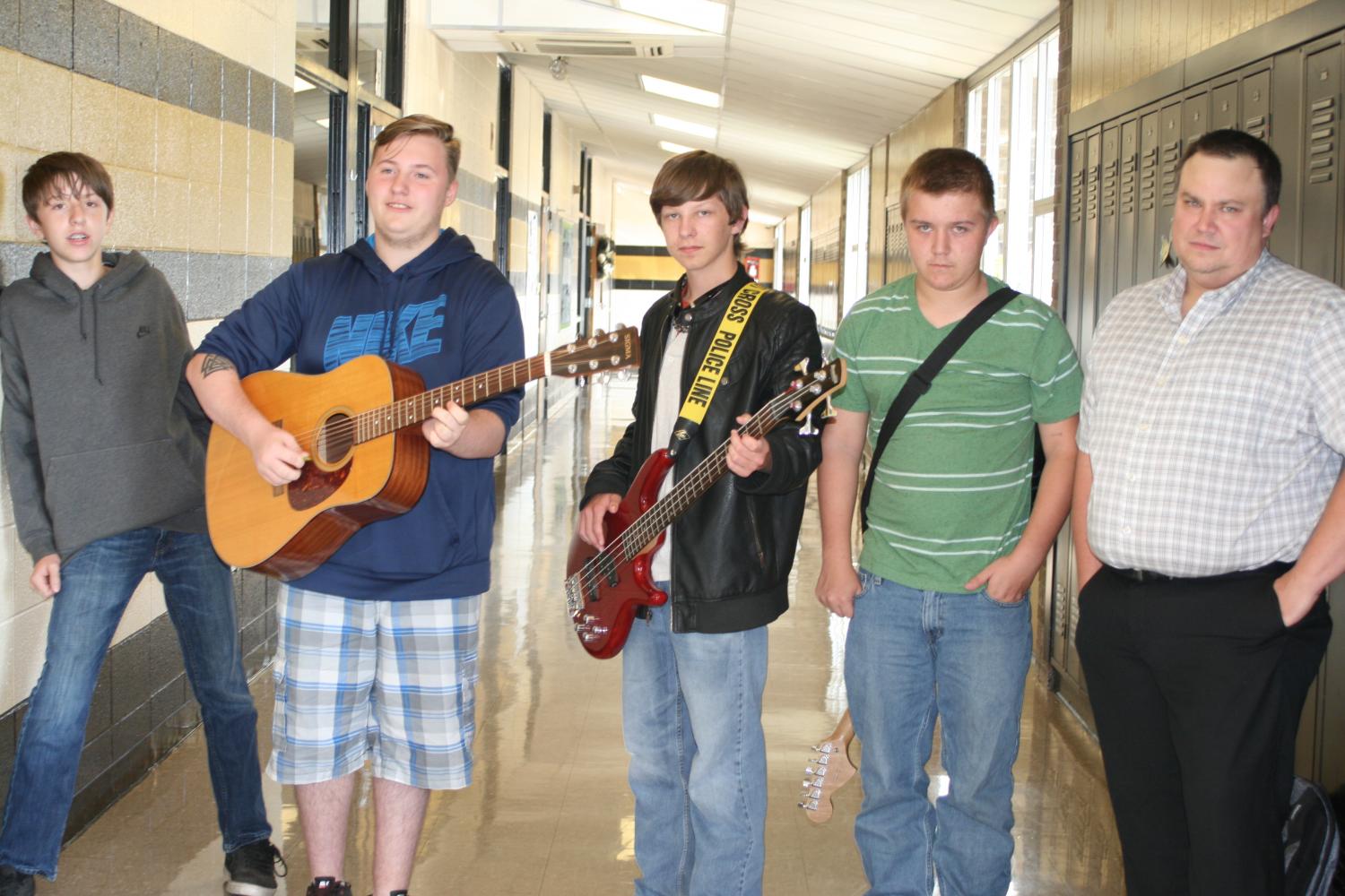 Mr.Maas, Hunter Bellew, Jacob Pinkley, Devin Martin, and Brent Turnbough pose for the camera with their guitars.