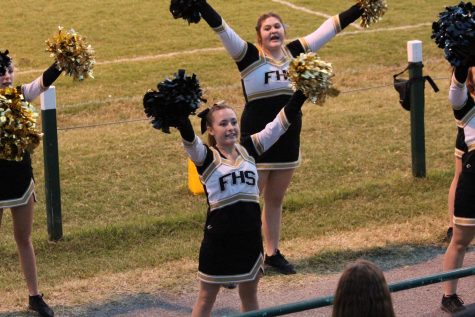 Jacquelyn Cowsert and Lanie Wade performing a cheer at an away game against Perryville