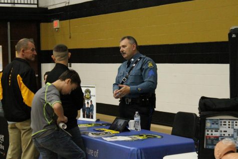 Students and teachers visit the table sponsored by the Missouri State Highway Patrol.