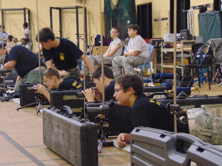 Daniel Gerler, Chris Lilley-Flick, Daniel Whitehead, and Wyatt Matkin preparing to fire from the prone position