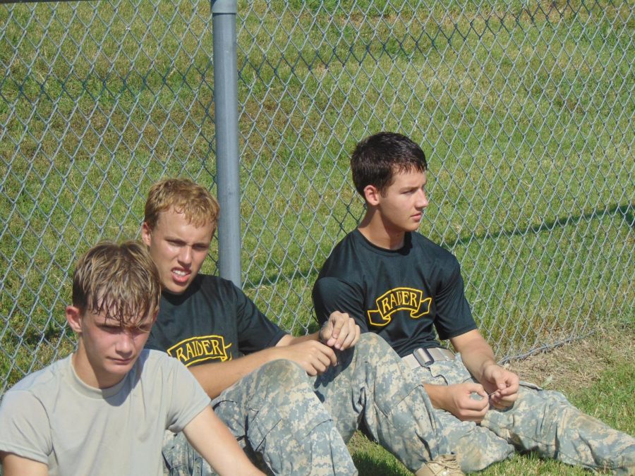 Ethan Wheeling, Blake Olson, and Aaron Cooper are seen resting between events