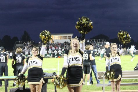 Seniors Anne White, Leah Lindsey, and Caylee Wright cheering on the Blackcats at Homecoming 2018