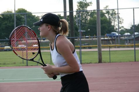 Sophomore Skylar Hennen prepares to play her singles match at a home game.