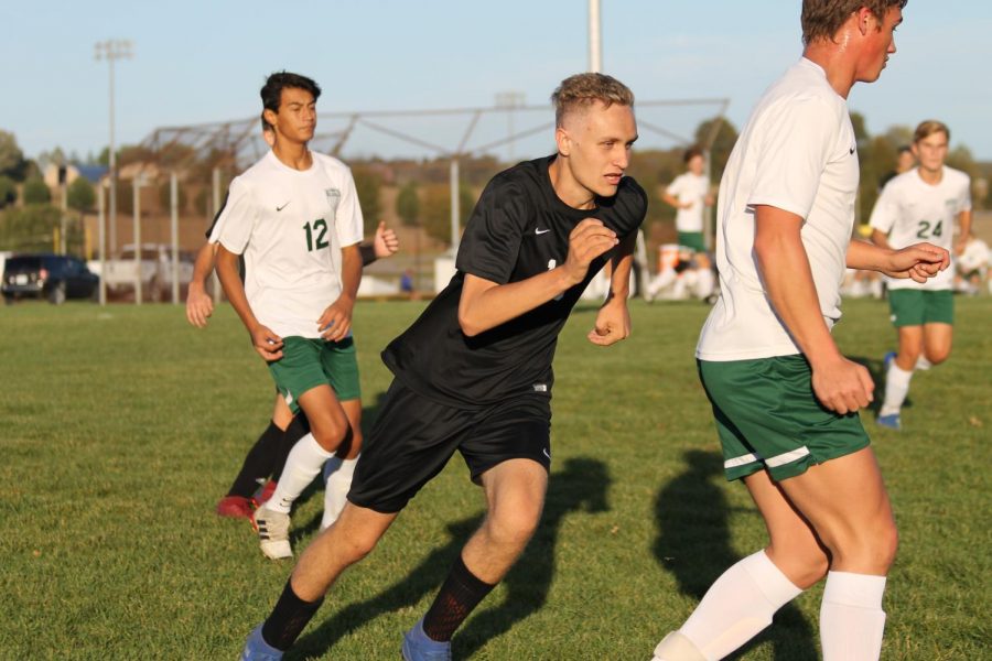 Senior Will Arras, 13, runs to catch up to the ball.