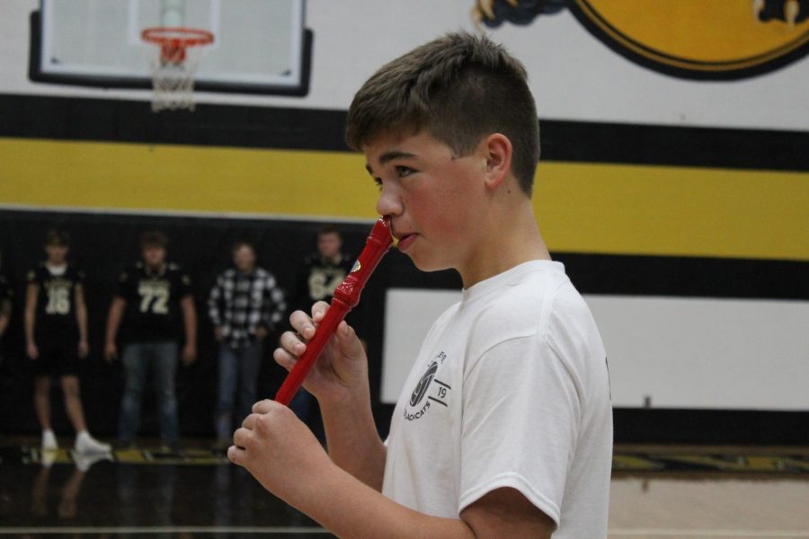 McCoy Clark, Freshmen, playing a flute with his nose.