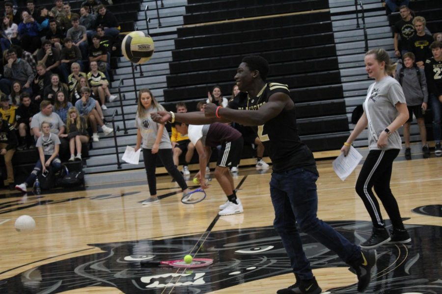 Malachi Kyle, Junior, one of the football representatives, bumping the ball down the court. 