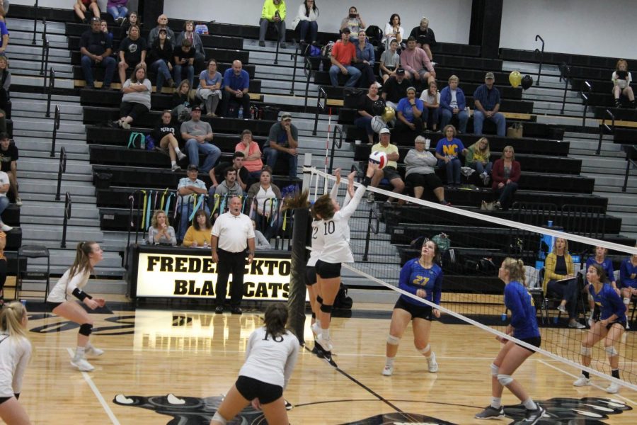 Freshmen Linley Rehkop (number 10) jumped up and sent the ball crashing down to the other side, scoring a point for the blackcats during the varsity game. 