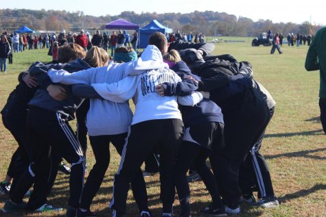 The cross country team huddled together one last time before districts.