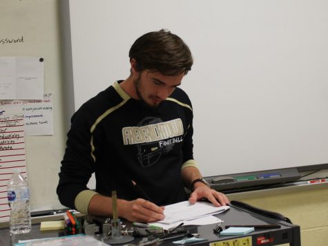 FHS graduate Mr. Kline busies himself setting up his new seating charts.