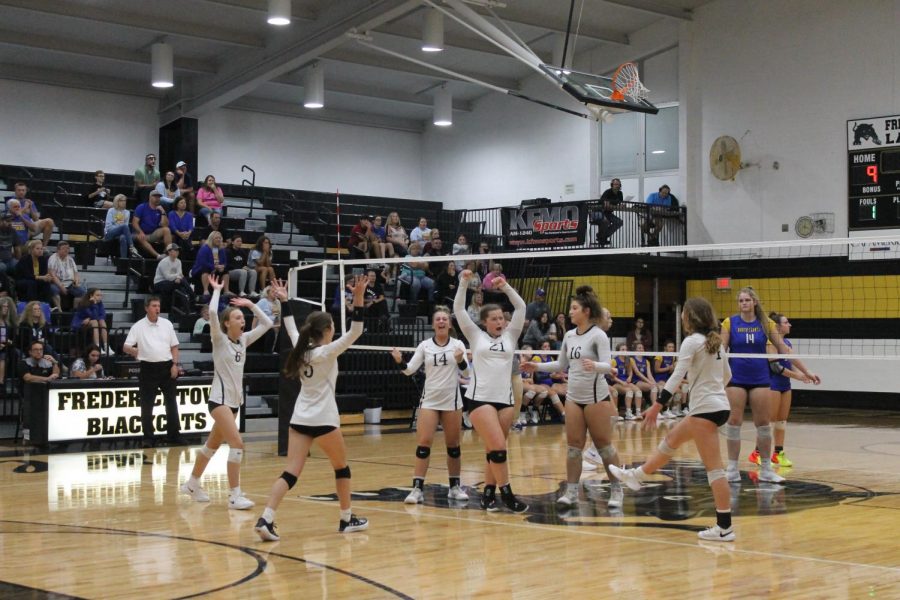 The Ladycats cheering after getting the point!