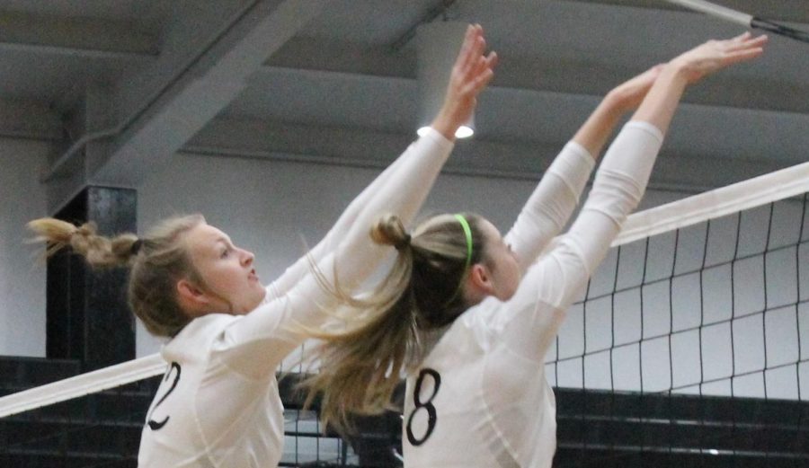 Kyndal Dodd (12) and Ryleigh Gresham (11) blocking the ball from meadow heights #12 (Allie Bloom)