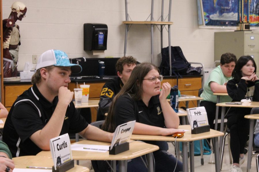 Varsity Scholarbowl members confused about a toss up question during their first round against Farmington.
