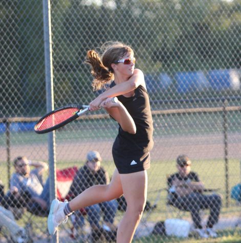 Clara Basden using her backhand to return the ball to her opponent in her singles match.