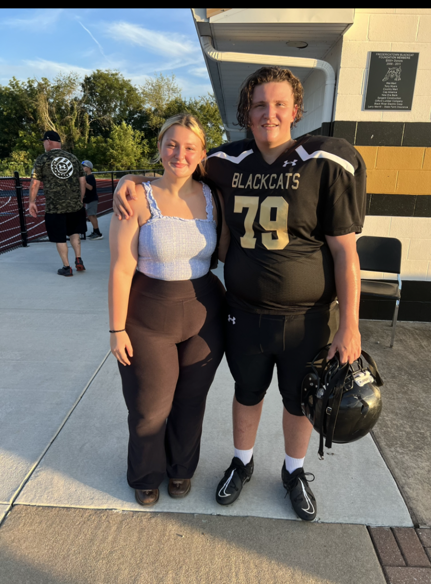 Head Editor Keeley Walker (11) with her brother Logan Walker (9) at the gatorade game. 