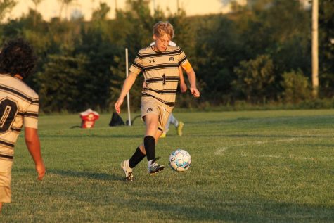 Nolan Sullivan (12) dribbling the ball to try to get a pass.