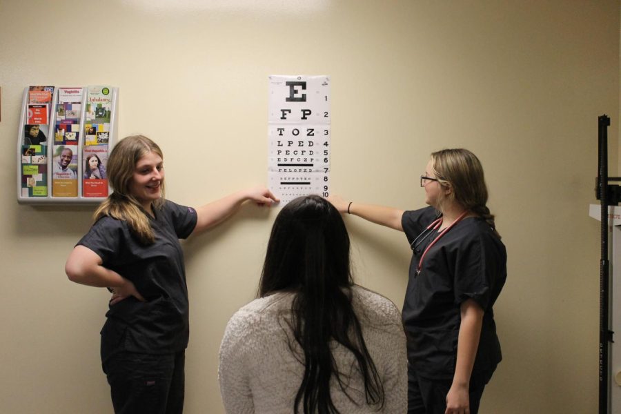 Lizzy+Cureton+%2811%29+and+Brianna+Stacey+%2811%29+practicing+how+to+give+an+eye+exam+on+a+patient.+