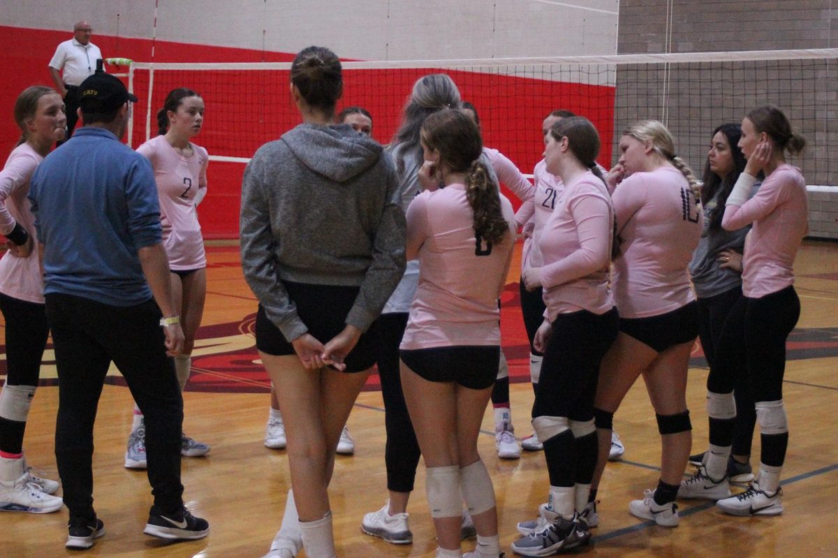 Mrs. Reutzel talking with the team during a time out while up against Cape Notre Dame. 