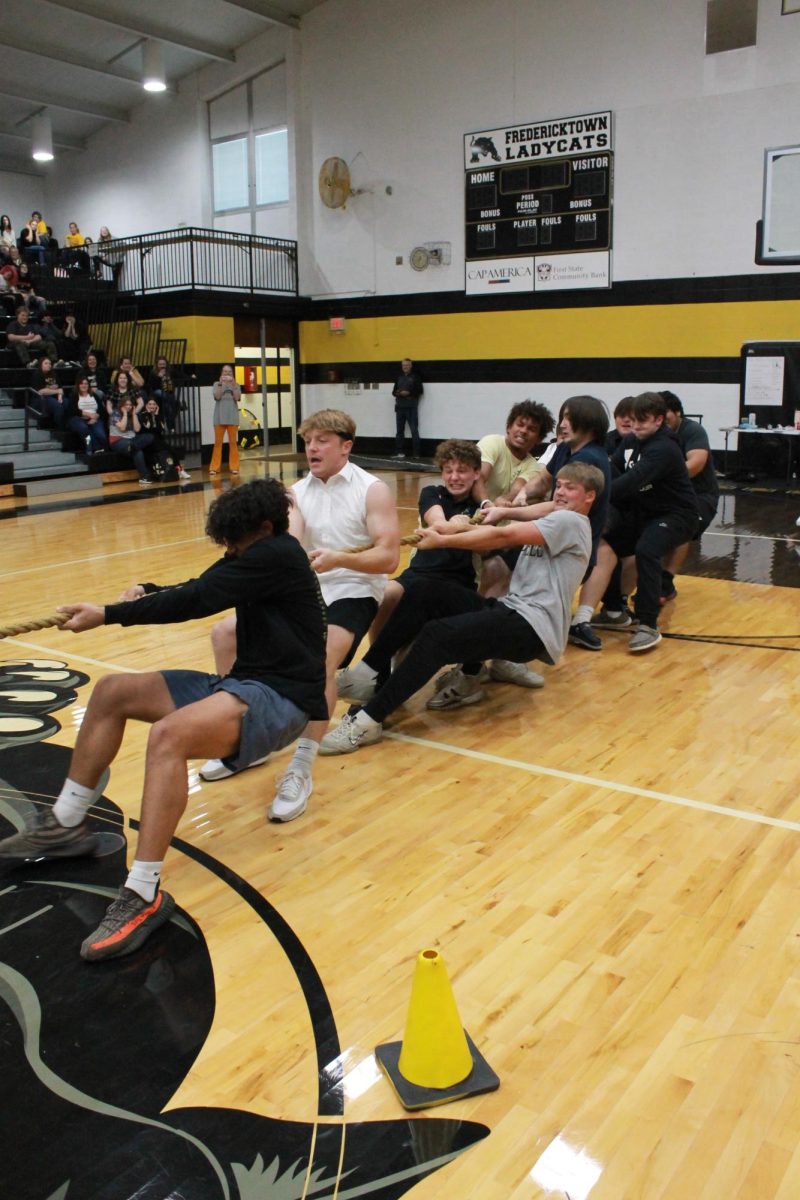 The juniors struggling to make the win during the game of tug-of-war against the seniors. 
