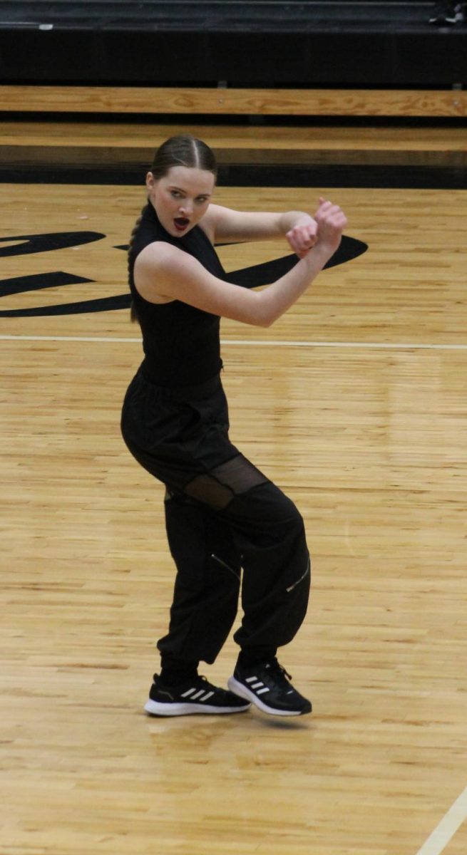 Sophomore Callie Rice performing an eye-catching move, while moving to the front of the floor. 