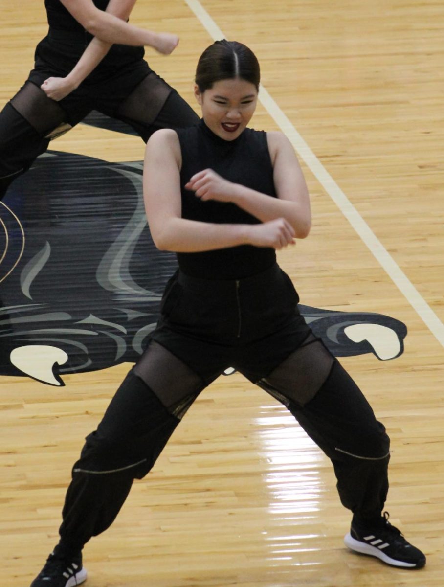 Sophomore Linda Yang crossing her arms in front of her body during the Hip-Hop performance before Farmington Invitational on January 13. 