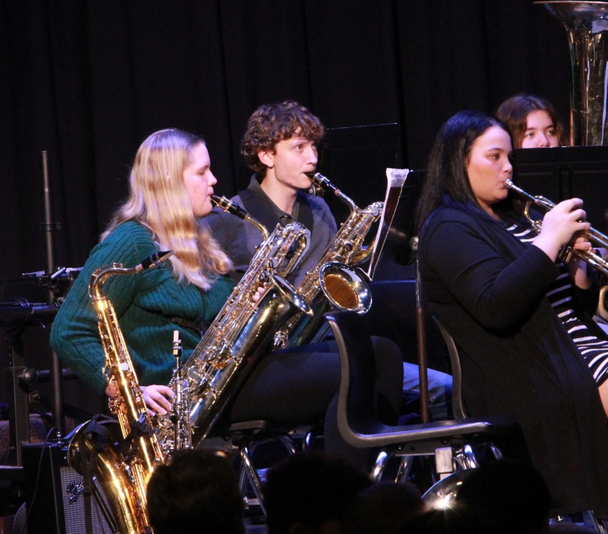Alto sax players Molly Clauser (9) and Dalton Cain (10) and trumpet Kyle Baca playing Collective Christmas.