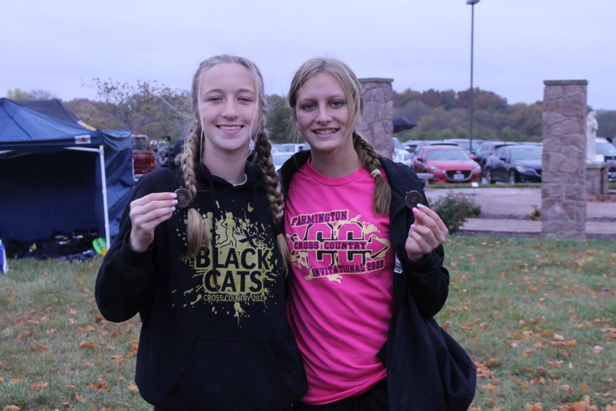 Breanna Bone (9), who finished 8th, and Laila Stevens (9), who finished 7th, with their medals from the Class 3, District 1, meet at Notre Dame High School in Cape Girardeau on October 28. These placings allowed the runners to enter the state meet in Columbia, Missouri, on November 4.
