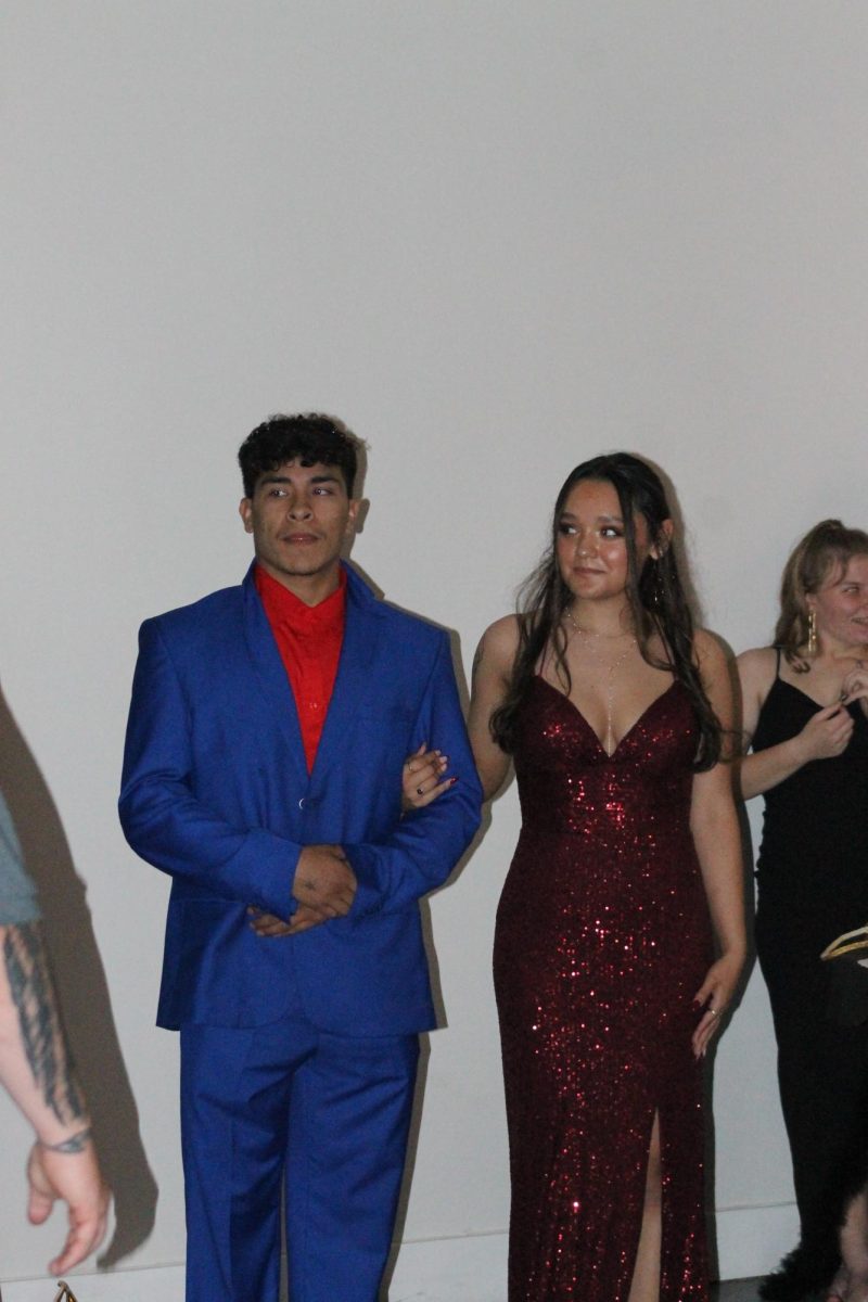 Ruben Pirtle and Mariela Vazquez looking at Gage as he is announced prom king. 