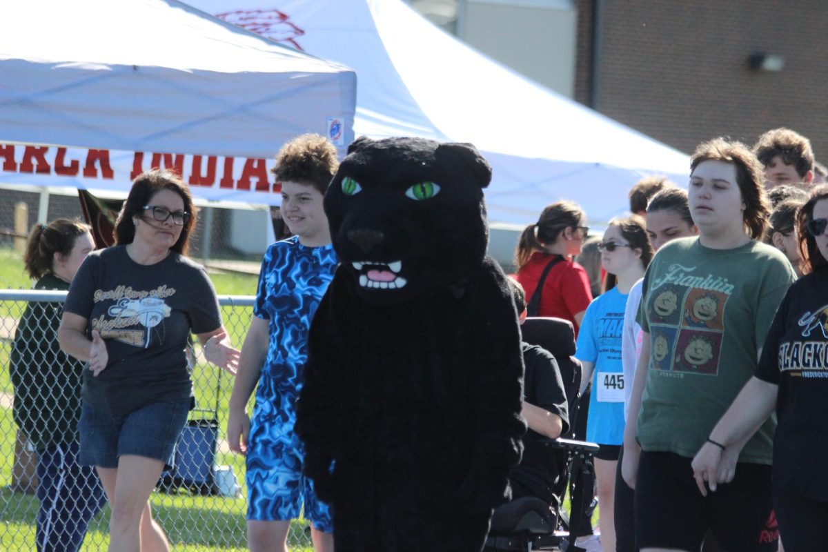 The Blackcat mascot with a couple of players ready to march out on cue.