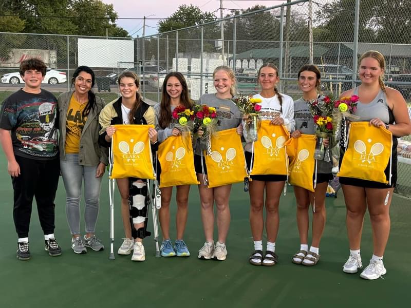 Coach Angie Francis and manager Keagan Keith standing beside the seniors after receiving their gifts.