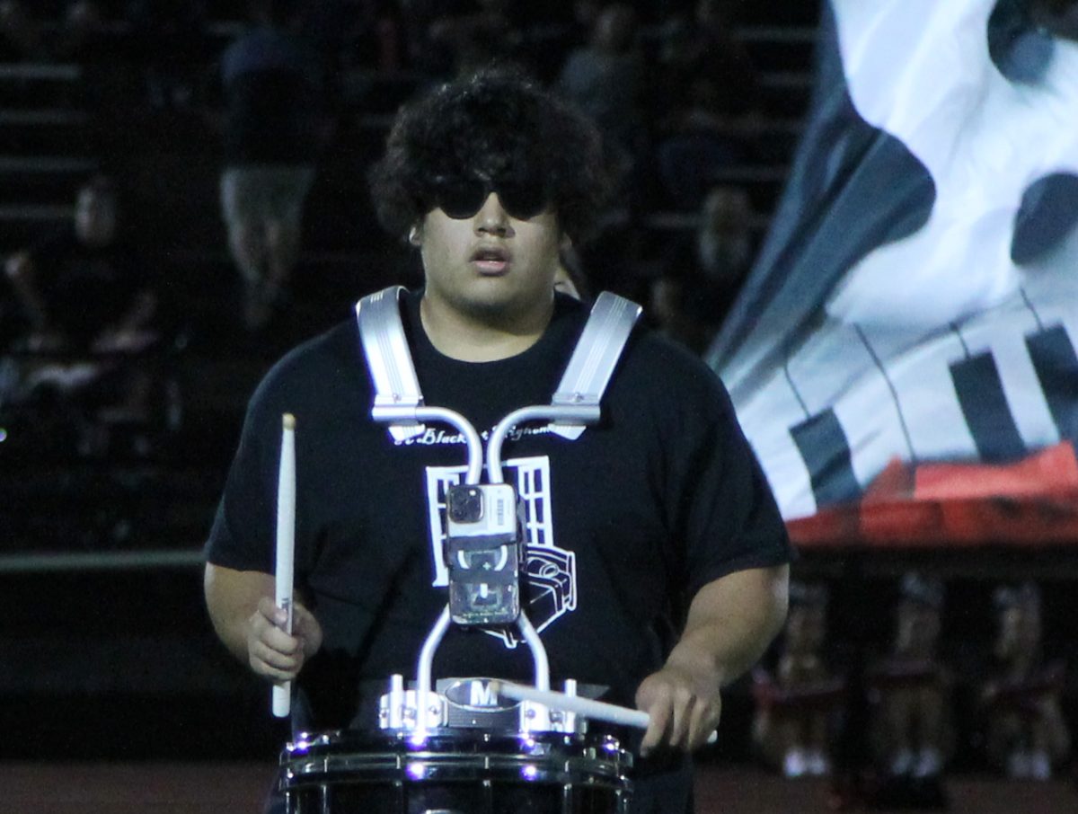 Owen Henson (12) playing the snare drum during the halftime marching performance. 