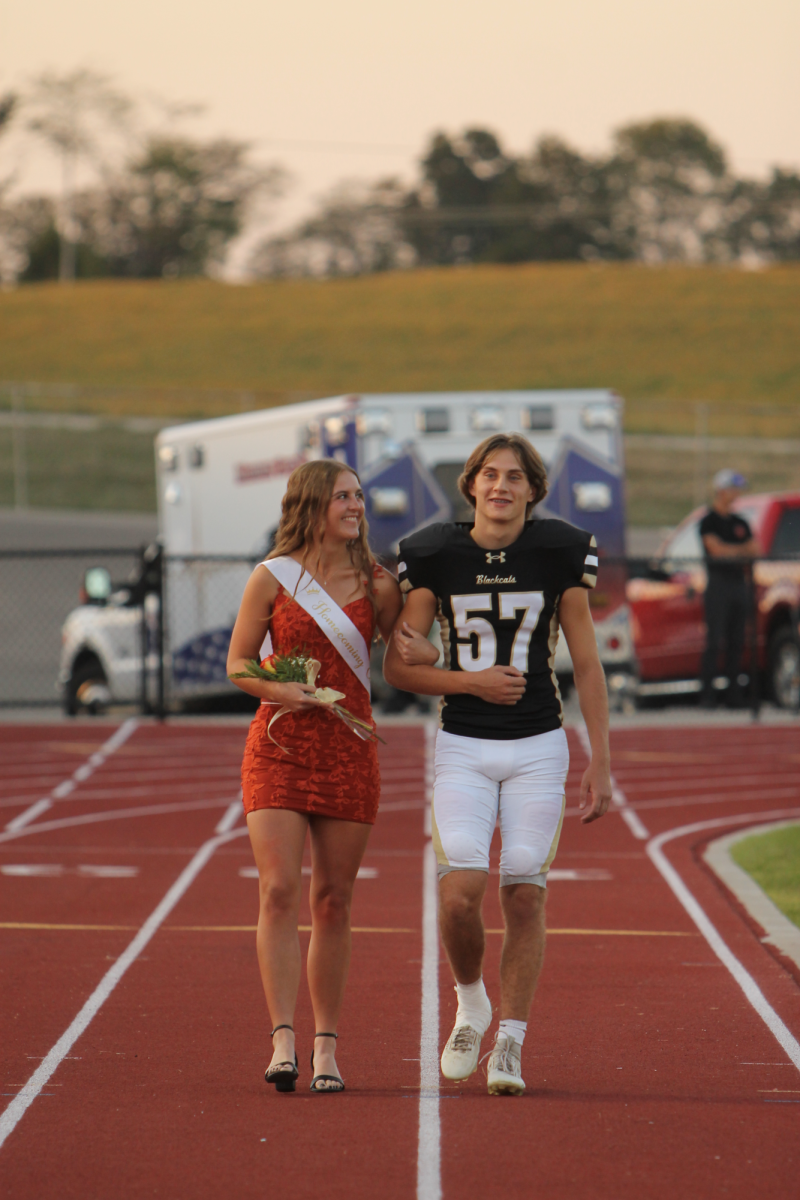 Childhood best friends Lexi Rehkop and Donnie Laut laughing as the announcer shares their favorite memories, Lexi and her friends making Donnie do everything for them. 