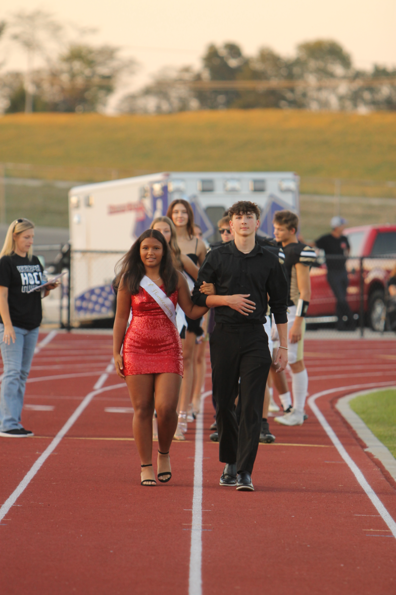 Freshman Jazara Catchings and Mason Cureton walking the track while information is shared about their futures. 