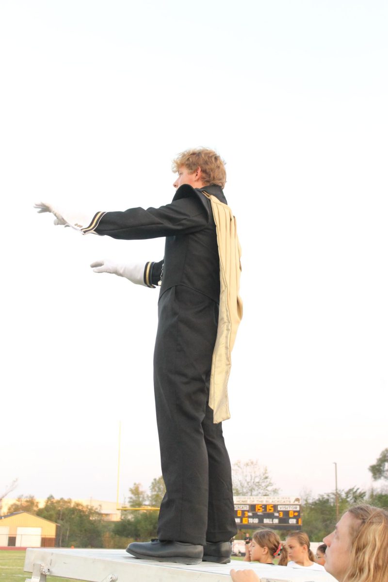 Carter Hale (11) leading the band during the national anthem at the home game against Valle Catholic. 