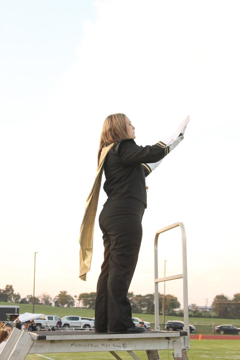 Adrienne Cox (11) directing the band during the pre-game performance. 