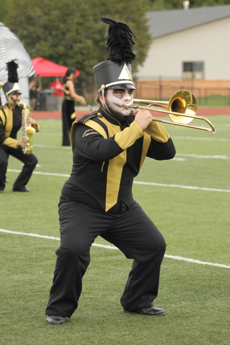 Franky Gullett (11) squatting for a visual before bringing his horn to the sky. 