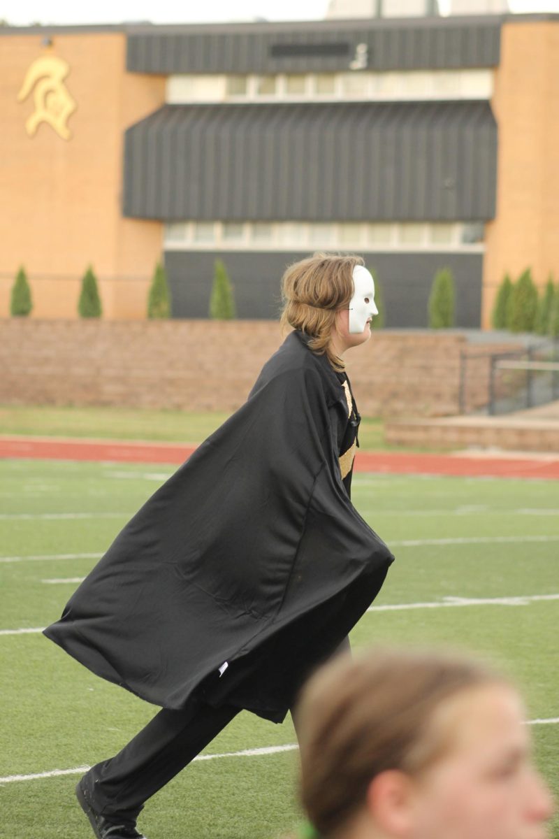 Alex --- chasing after Abby Roach (12) during the band's playing of a piece from Phantom of the Opera. 