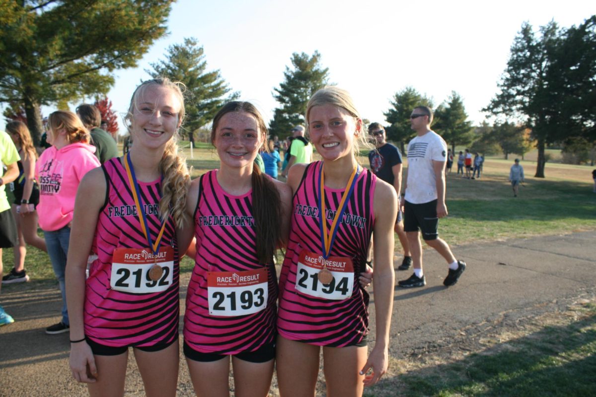 Senior Maddie Phares poses for an end-of-the-season photo with her sophomore teammates Breanna Bone and Larkin Strong.