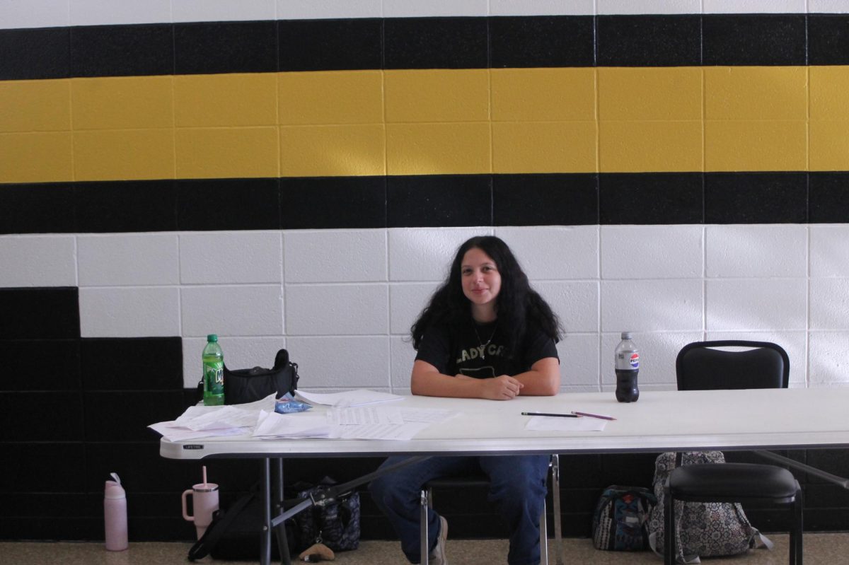 Alyson Collins (12) guides presenters to the right places in the gym.