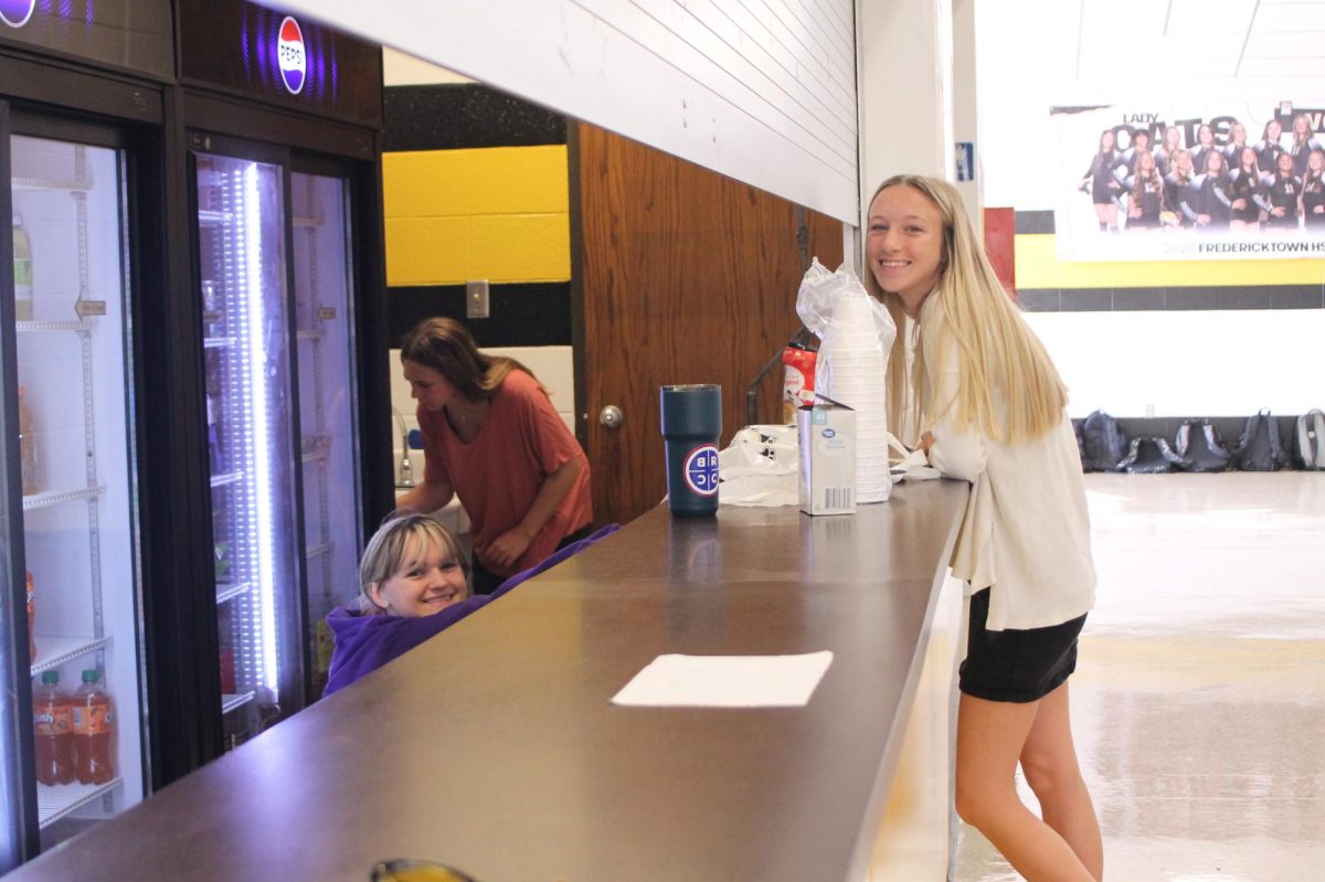 Noah Vogler (11), Jillian Hinkle (10), and Breanna Bone (11) work the refreshments table to keep visitors happy.