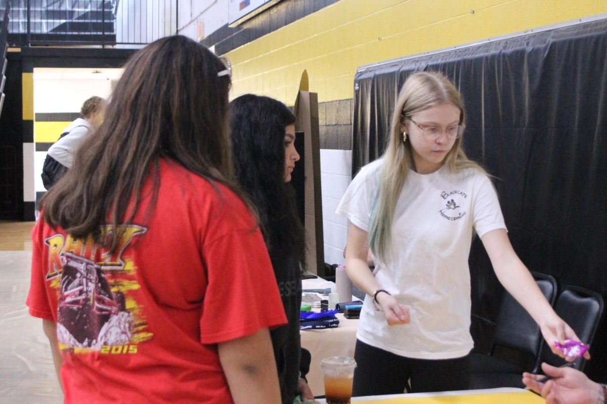 Allyson Blair (10) serves drinks and Skittles to presenters at this year's fair.