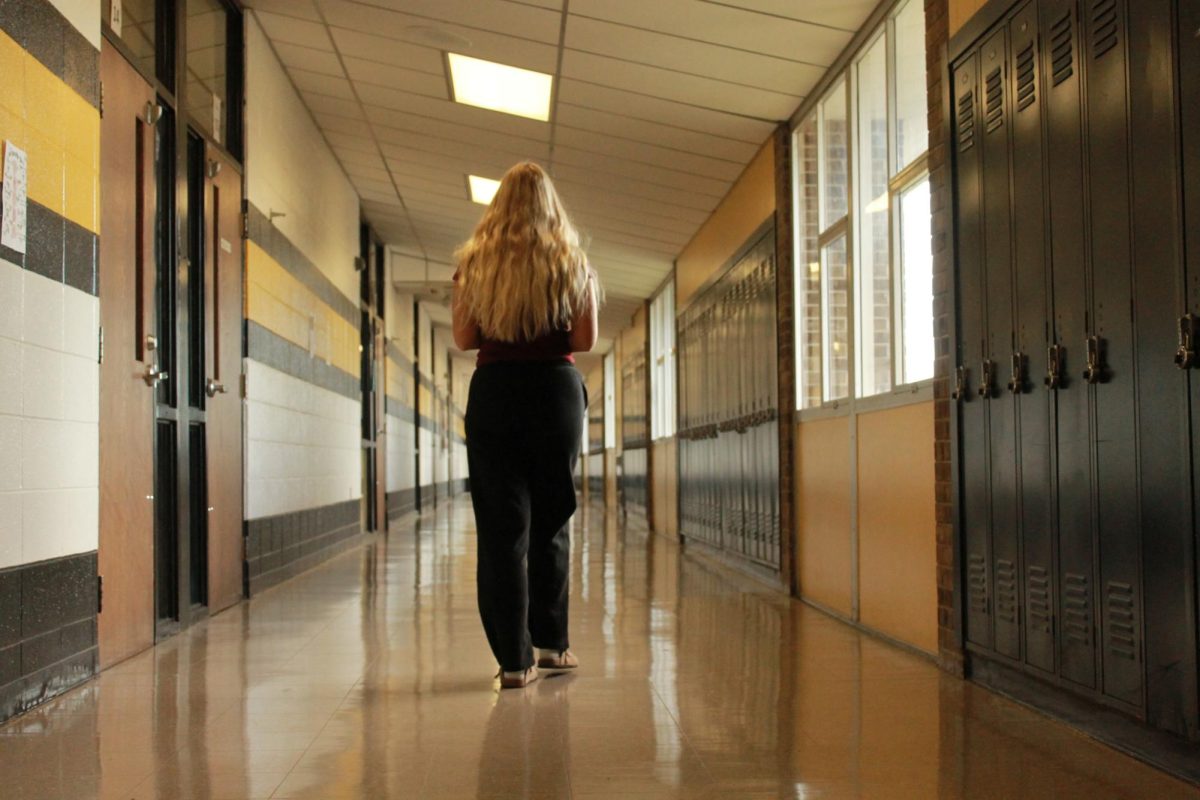 Claire Warden walking in the hallways.