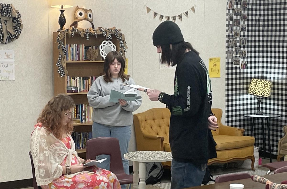 Students Sophie Haferkamp (11), Bailey Goforth (9), and Josh Ward (12) practicing for the play "Fireflies."